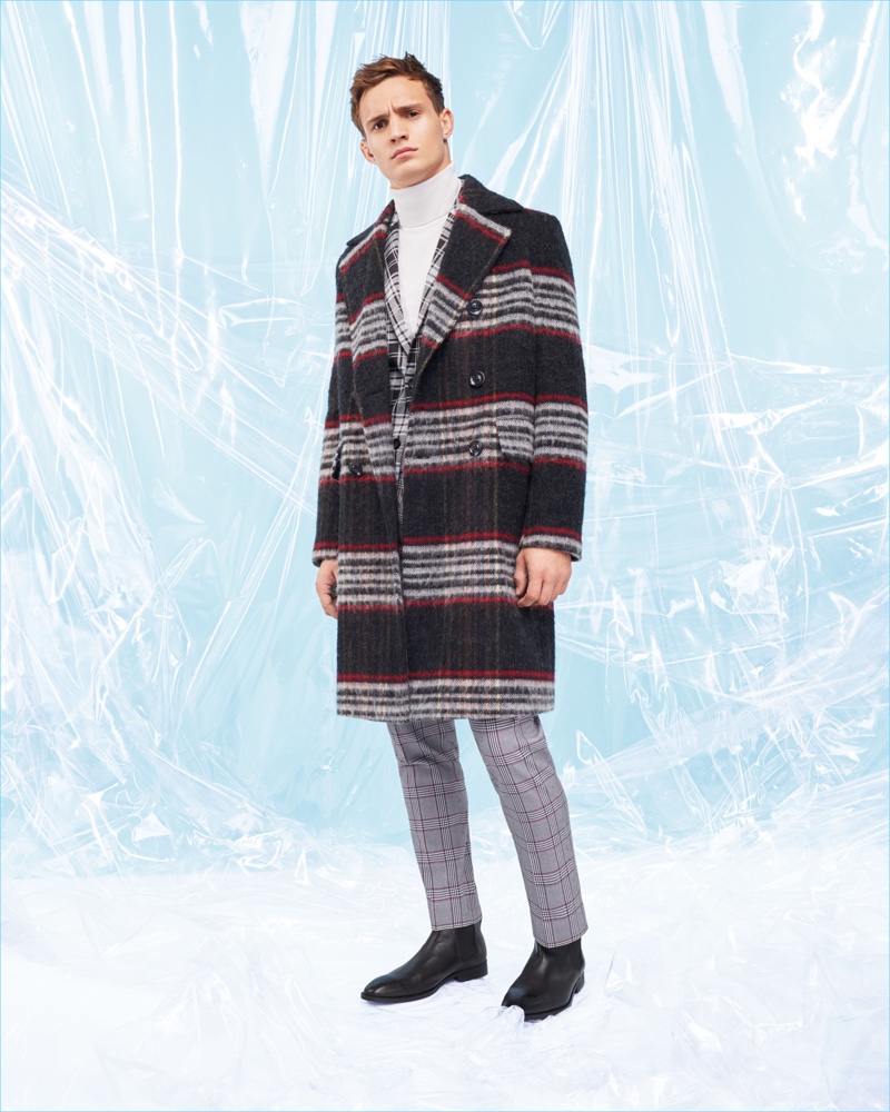 Top model Julian Schneyder dons a check coat, jacket, and pants from River Island.