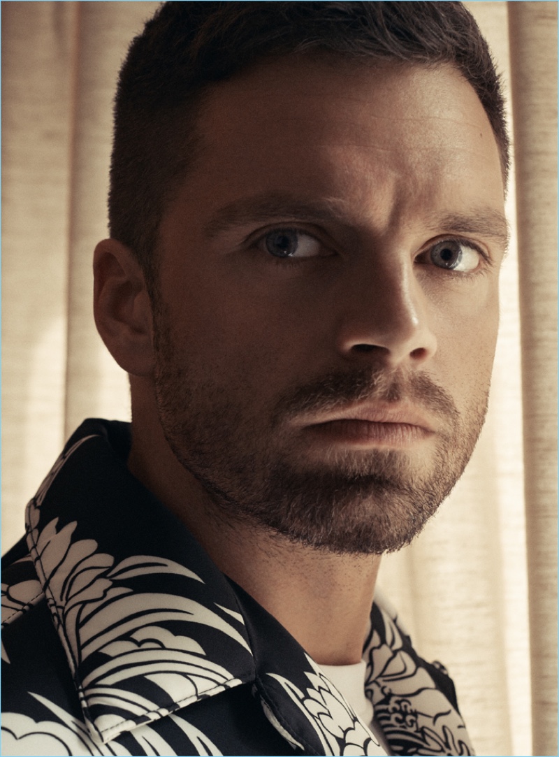Embracing a tropical print, Sebastian Stan wears a shirt by Prada.