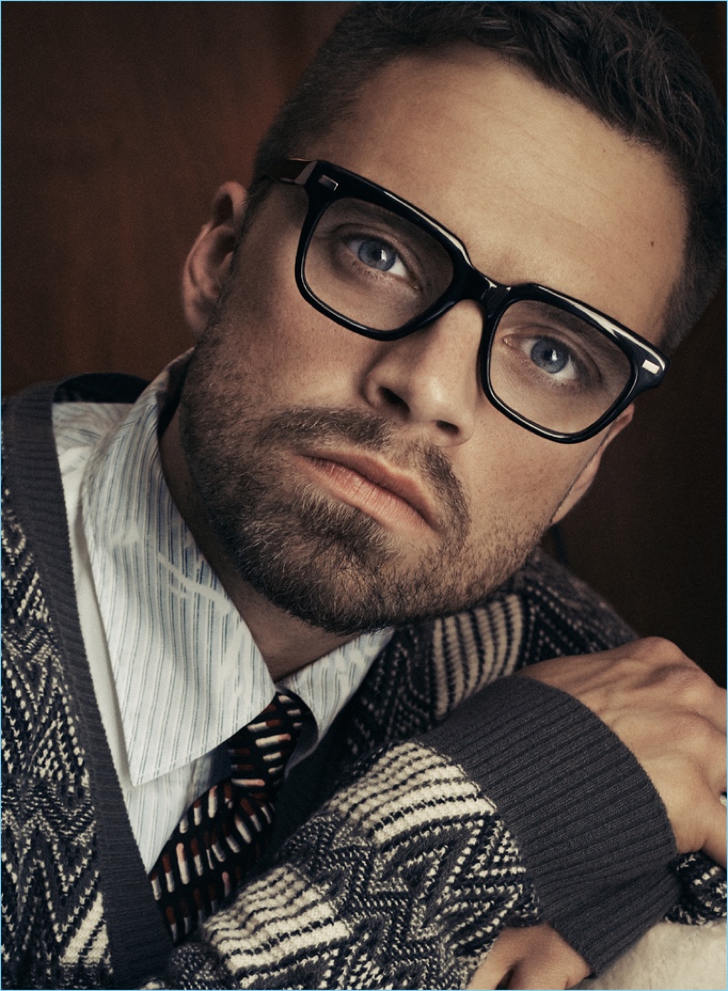 Sebastian Stan wears glasses for a photo shoot featuring Prada clothes.