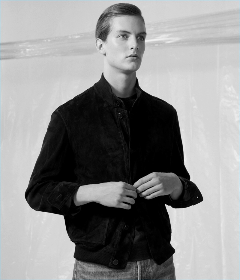 Sporting The Row, Kajus Valciukas wears a suede blouson jacket with denim jeans.