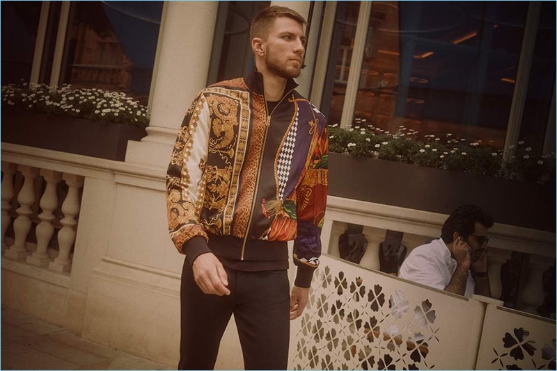 On the move, Andrew Pozzi sports Burberry jeans with a Versace t-shirt and track jacket.