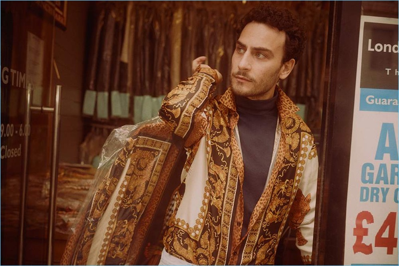 Cesare Taurasi dons a Versace track jacket, Handvaerk t-shirt, and A.P.C. white denim jeans.