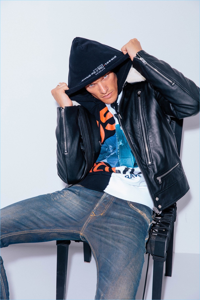 A cool vision, Danny Beauchamp wears a Diesel leather jacket, jeans, and hoodie.