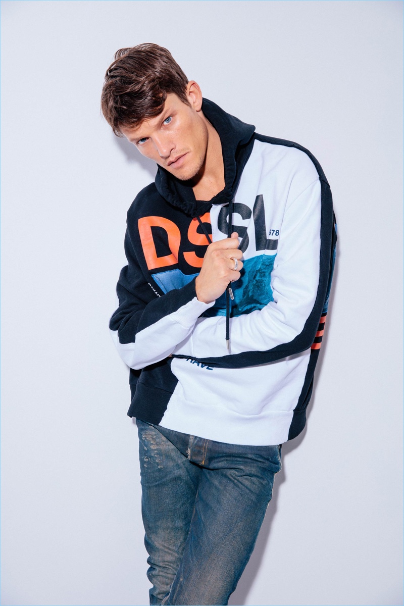 British model Danny Beauchamp wears a hoodie and jeans from Diesel.