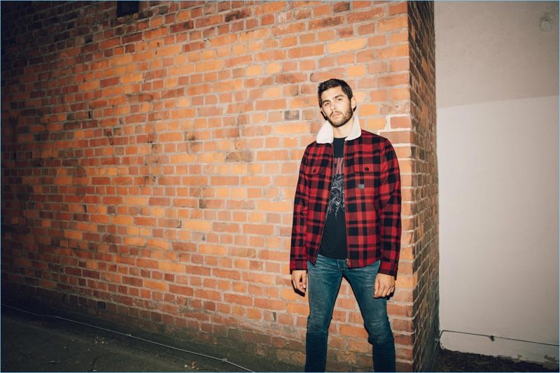 René Grincourt sports a Vintage Industries jacket with a Replay t-shirt and Diesel jeans.