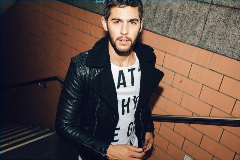 Connecting with THEO, René Grincourt wears a Tigha leather jacket, Jack & Jones jeans, and a Tigha t-shirt.