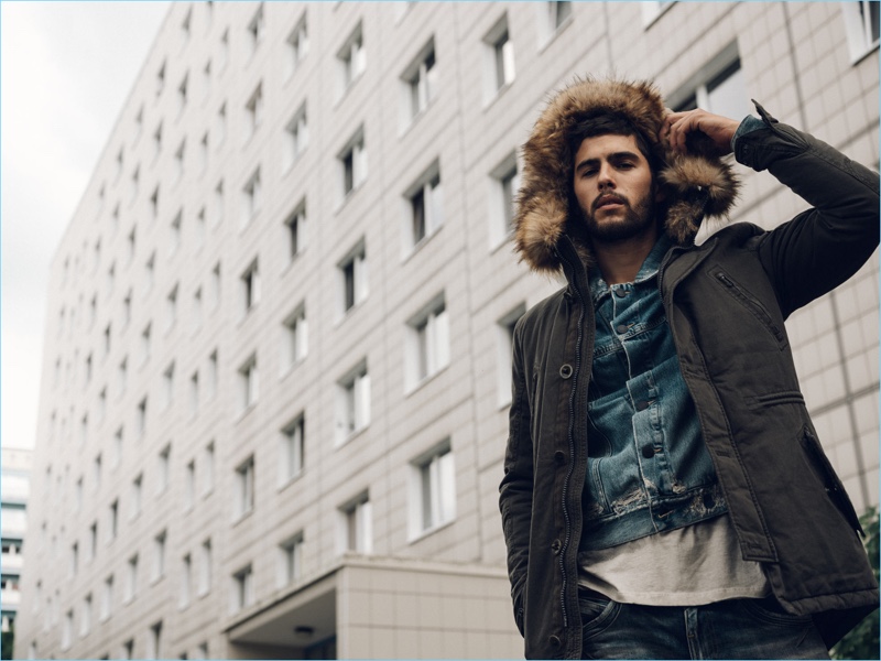 Model René Grincourt dons an Autark jacket, Jack & Jones jean jacket, LTB jeans, and Tigha t-shirt.