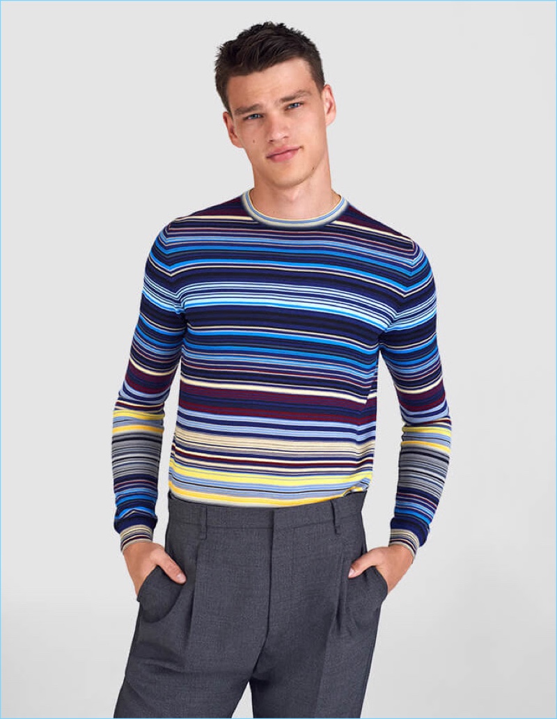 Sporting Prada, Filip Hrivnak wears a striped sweater.