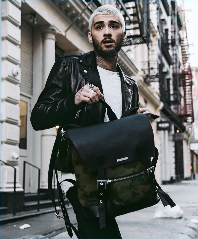 Singer Zayn Malik poses with a backpack from his collaboration with The Kooples.