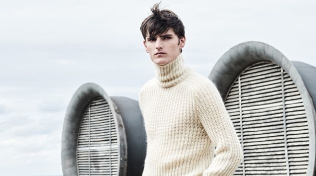 A chic vision, Alexander Beck dons a turtleneck sweater with trousers from Hugo Boss.