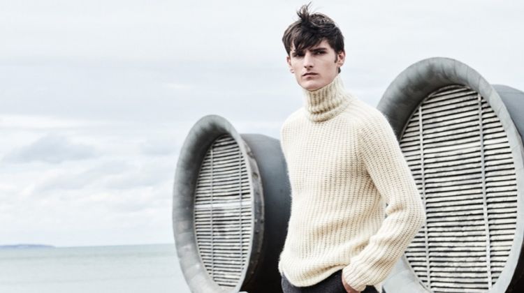 A chic vision, Alexander Beck dons a turtleneck sweater with trousers from Hugo Boss.