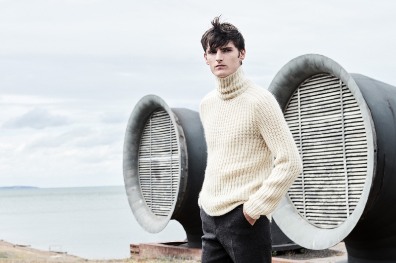 A chic vision, Alexander Beck dons a turtleneck sweater with trousers from Hugo Boss.