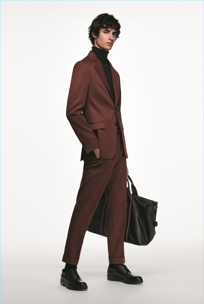 Oscar Kindelan dons a burgundy suit from the BOSS Made in Germany capsule collection.