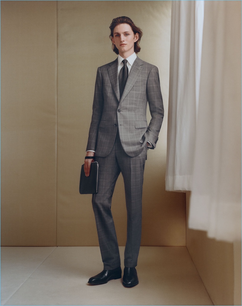 Front and center, Henry Rausch dons a plaid wool two-button suit by Cifonelli.