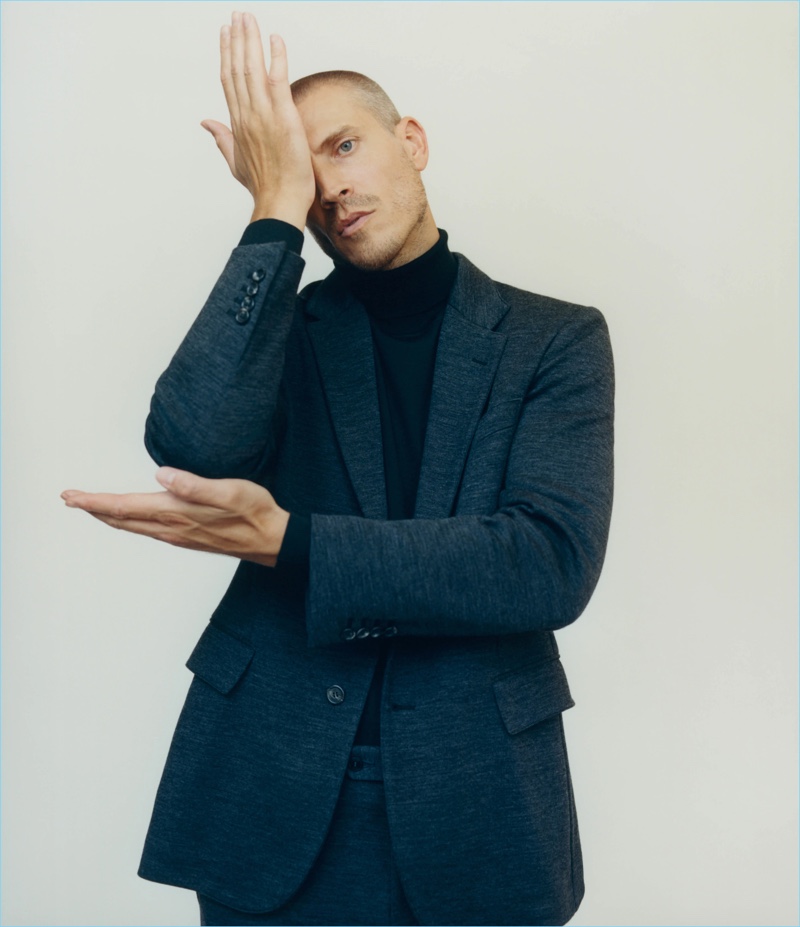 Mike Guenther dons a Brioni wool jersey two-button suit and wool-blend turtleneck.