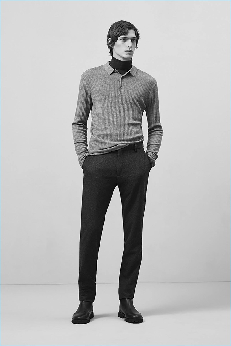 Model Edoardo Sebastianelli wears a ribbed polo sweater with a turtleneck and trousers by COS.