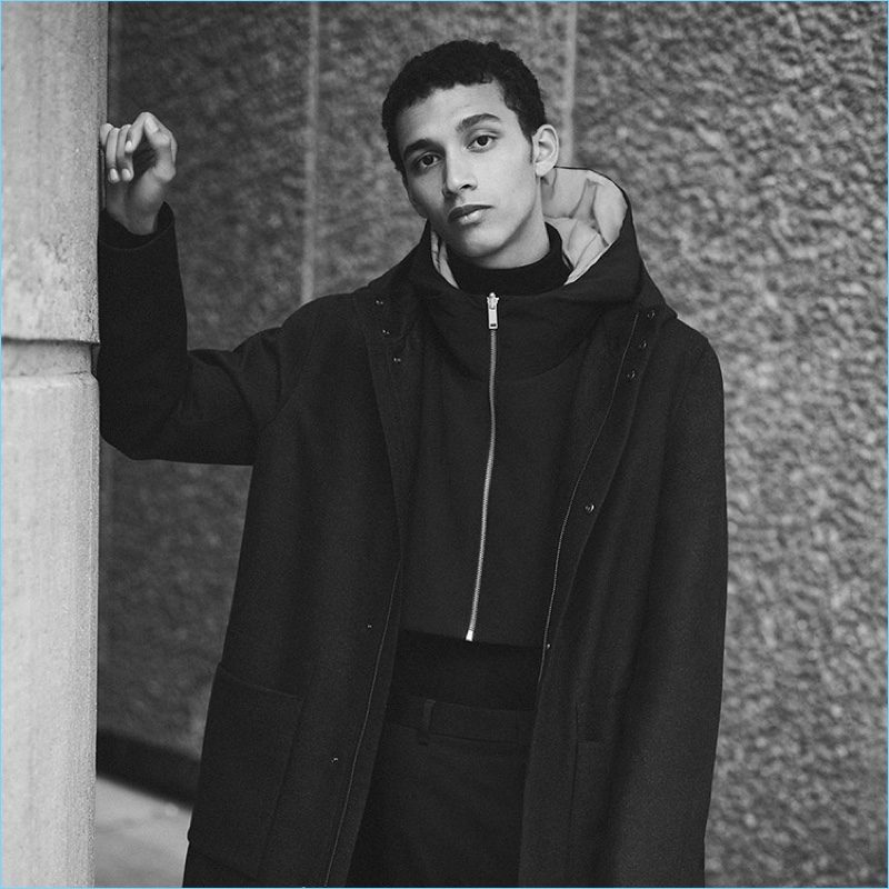 Layering for winter, Jackson Hale models a high-collar tailored jacket and wool anorak from COS.