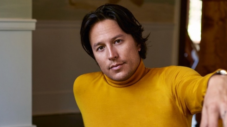 Cary Fukunaga dons a yellow turtleneck from Z Zegna with Sandro pants and a Tom Ford belt.