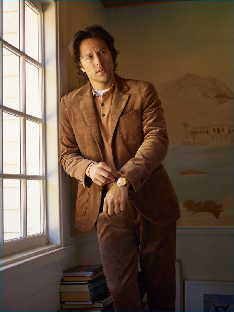 Donning a Brunello Cucinelli suit and polo, Cary Fukunaga also wears a Calvin Klein t-shirt and Omega watch.