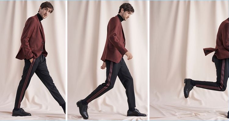 Hamilton Seguin wears a burgundy wool flannel blazer, varsity tape pants, and a coverlock turtleneck from Club Monaco. He also dons Wings + Horns Officer shoes.