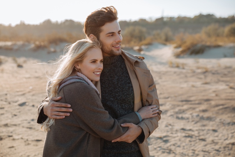 Couple in Sand Wearing Layered Looks