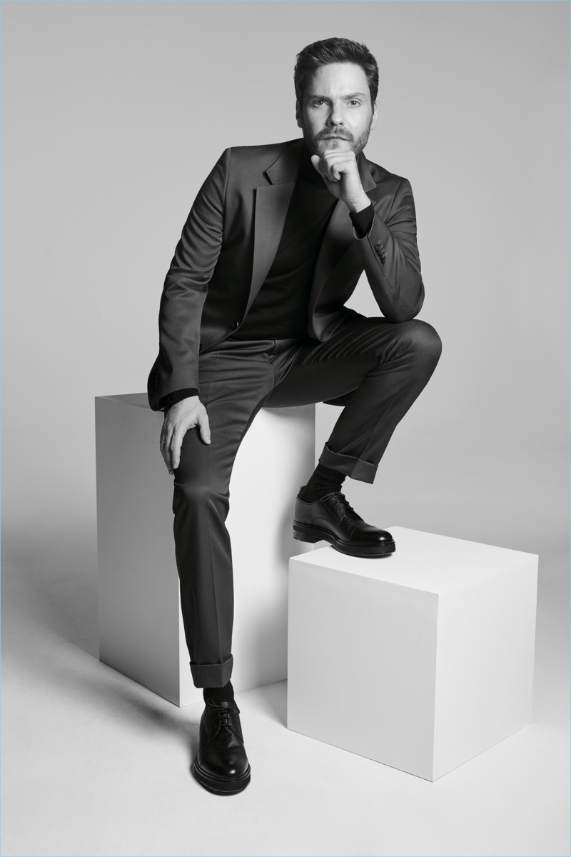 Donning a sharply tailored suit, Daniel Brühl fronts the BOSS Made in Germany capsule collection campaign.
