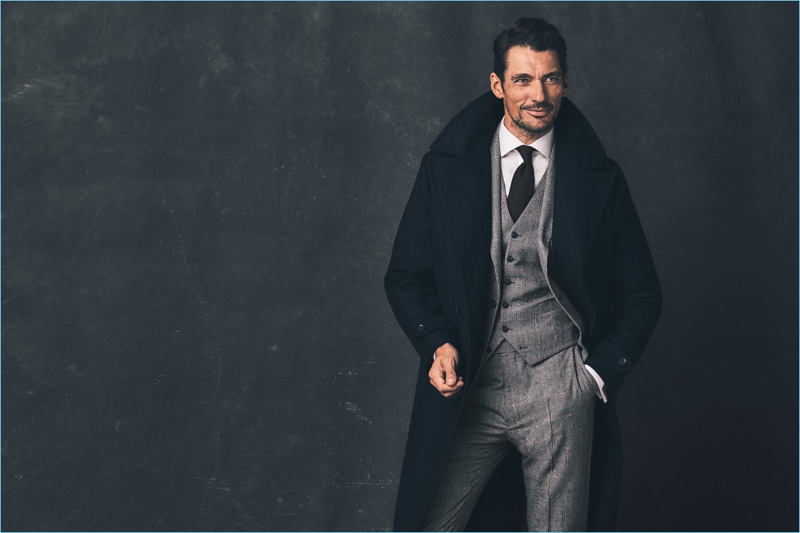 Donning a sharp wool overcoat, David Gandy is dashing in a three-piece suit from his Savile Row Inspired Marks & Spencer collaboration.