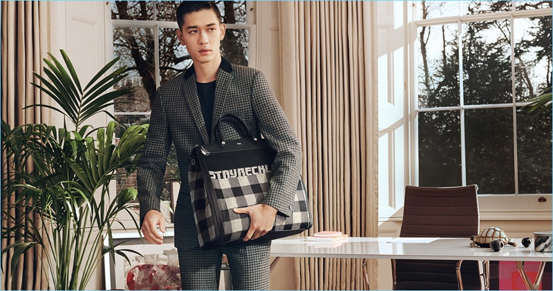 Keisuke Asano takes hold of Furla's Mercurio Tartan bag for its fall-winter 2018 campaign.