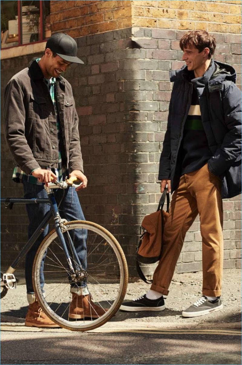 Left: Cameron Gentry wears a corduroy trucker jacket, denim jeans, flannel shirt, and suede boots. Right: Adrien Sahores rocks a parka, color-blocked hoodie, and corduroy pants.