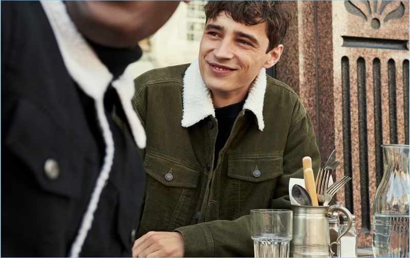 Adrien Sahores sports an olive green corduroy trucker jacket by H&M.