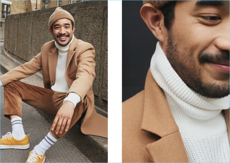 All smiles, Lucien Smith wears a rib-knit turtleneck sweater and a camel wool-blend coat from H&M.