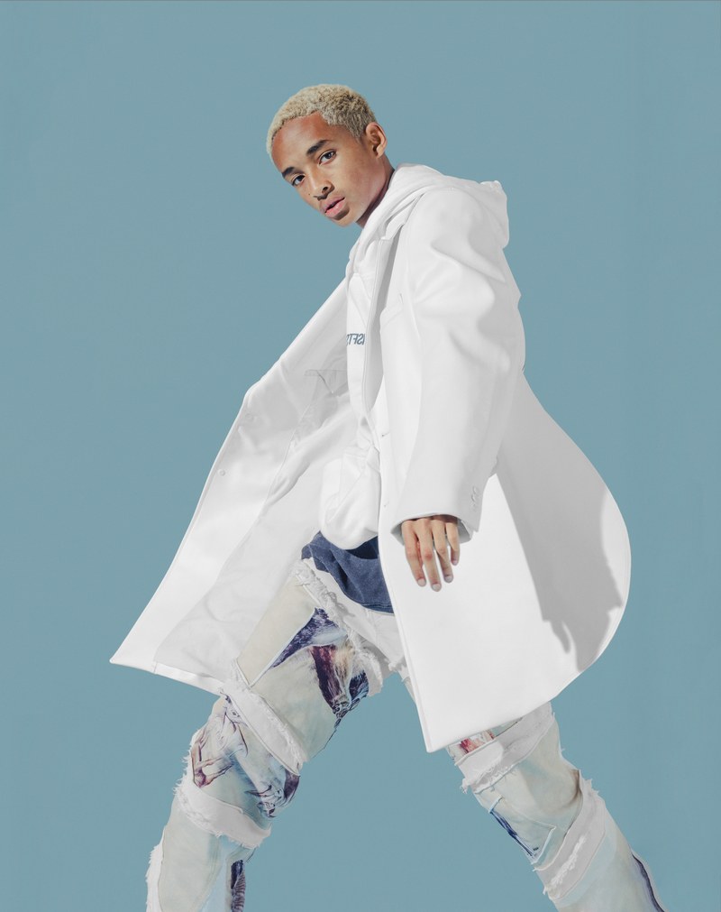 Jaden Smith dons a Comme des Garçons Homme Plus coat with a MSFTS hoodie. He also sports a t-shirt and jeans from his G-Star Raw Forces of Nature collaboration.