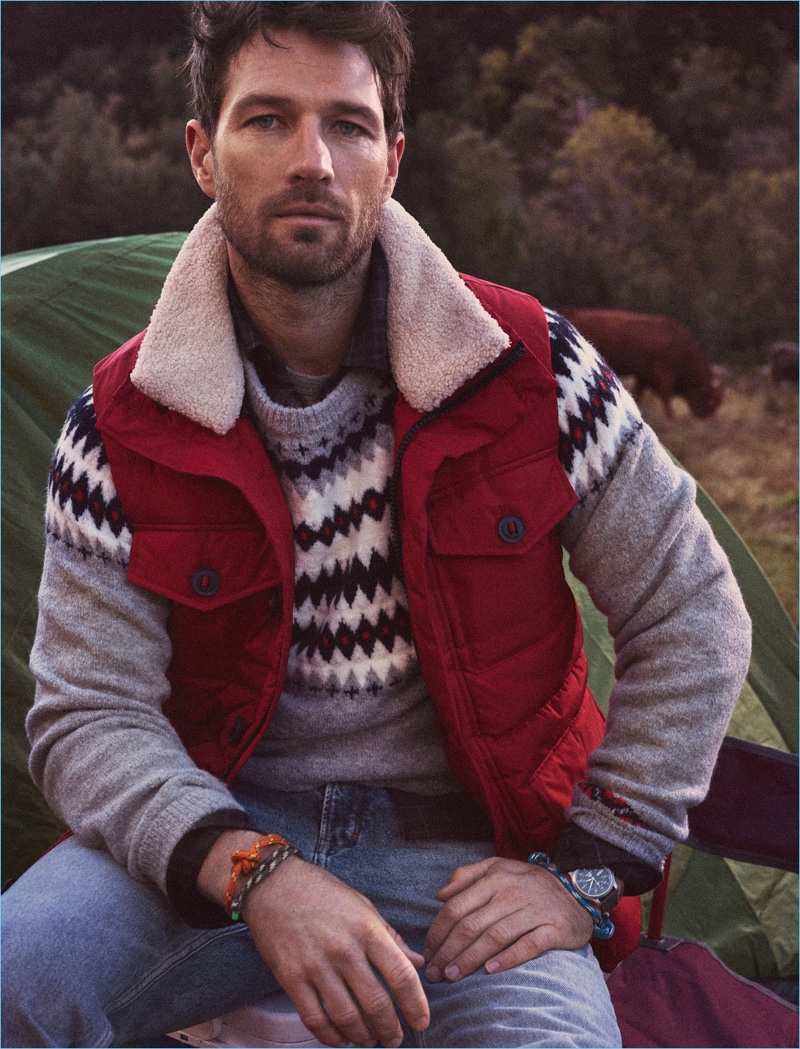 Vince Dickson sports a quilted vest and sweater with jeans from Mango Man.