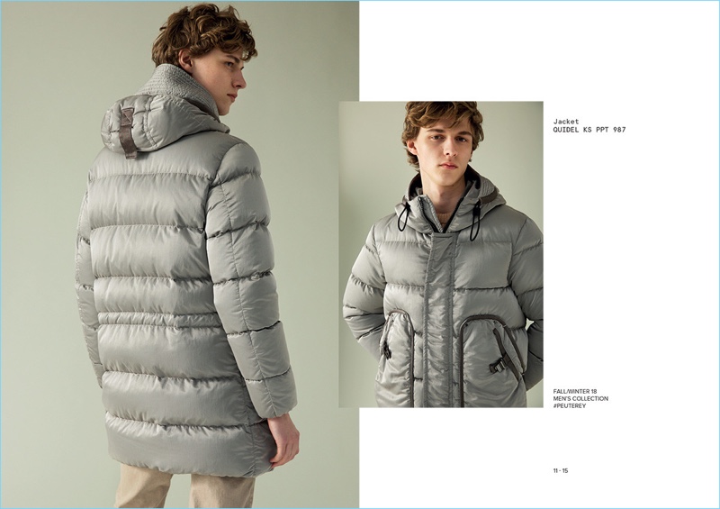 Prepared for the cold, Max Barczak models a light grey down jacket from Peuterey's fall-winter 2018 collection.