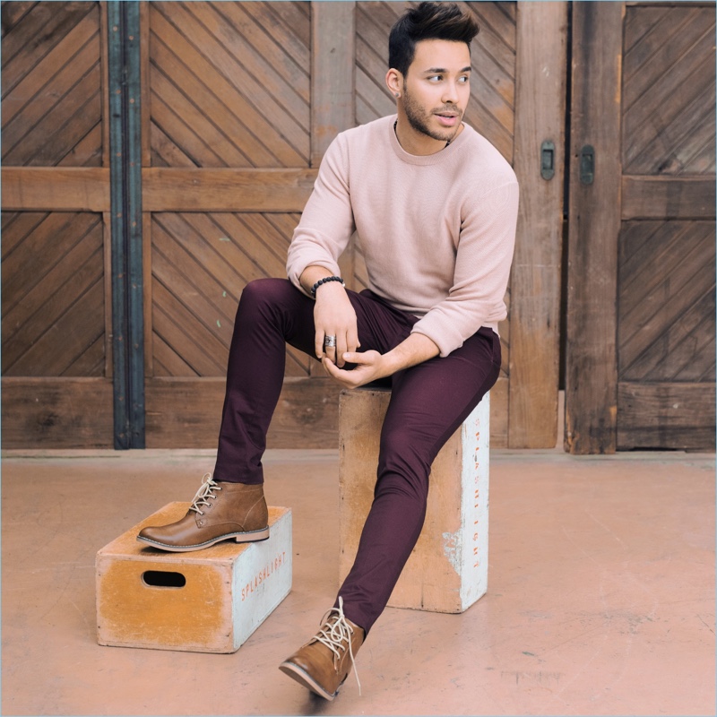 Going casual, Prince Royce sports a H&M sweater with pants and desert boots.