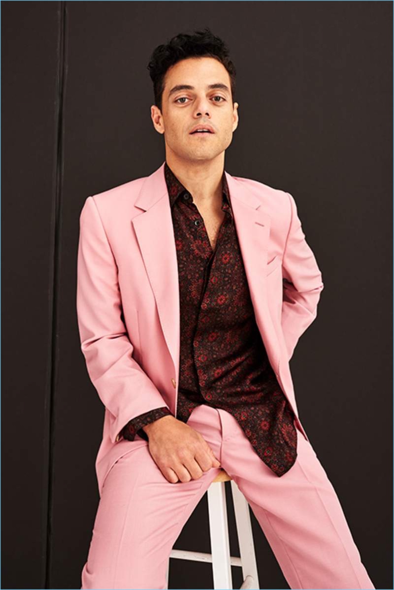 Front and center, Rami Malek dons a pink Alexander McQueen suit with a Saint Laurent printed silk shirt.