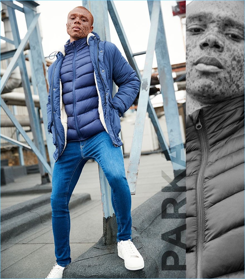 Parka: Ralph Souffrant wears a River Island navy hooded borg lined jacket with a front funnel neck puffer jacket.