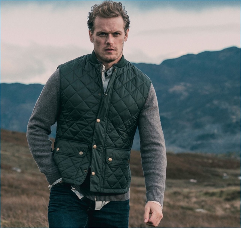 Sam Heughan wears a quilted vest from his Barbour collaboration.