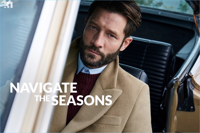 Reuniting with Simons, John Halls wears a LE 31 Italian Piacenza overcoat, cable-knit sweater, and semi-tailored fit shirt.