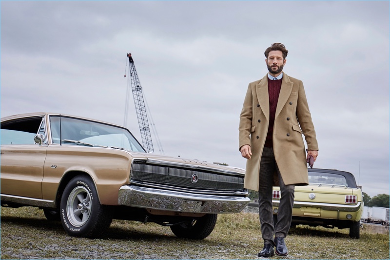 Stepping out, John Halls dons a LE 31 Italian Piacenza overcoat, cable-knit sweater, gingham pants, and a semi-tailored fit shirt.