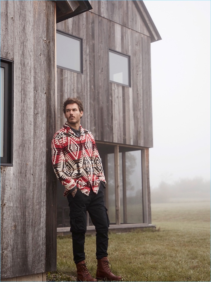 Connecting with Simons, David Alexander Flinn models a LE 31 Ikat jacquard cardigan, flannel shirt, and cargo pants.