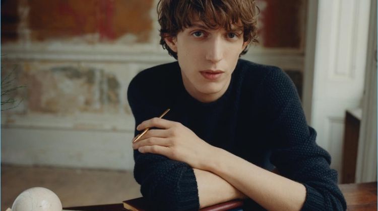 Sitting for a photo, Xavier Buestel poses with Smythson's leather-bound notebooks.