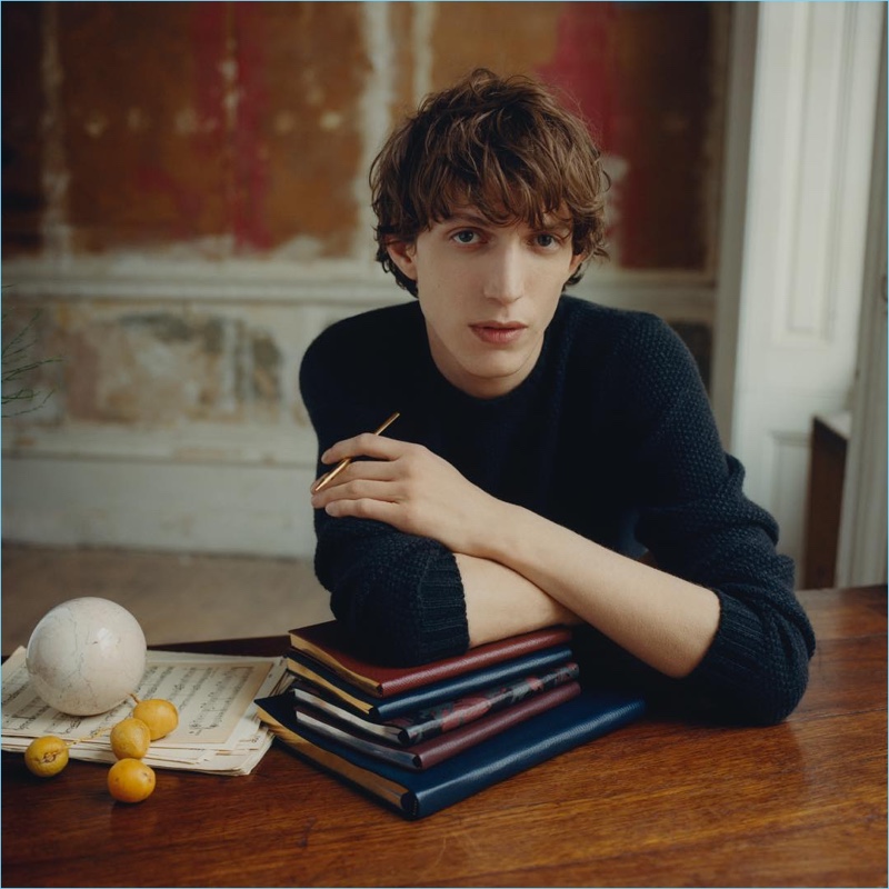 Sitting for a photo, Xavier Buestel poses with Smythson's leather-bound notebooks.