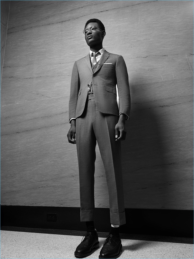Front and center, Youssouf Bamba dons Thom Browne's signature grey suit.
