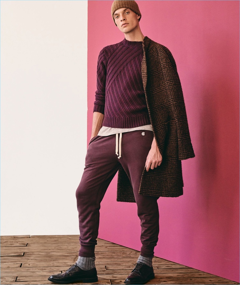 Warming up to autumnal hues, Rocky Harwood wears a hand-knit maroon cable crewneck sweater by Todd Snyder.