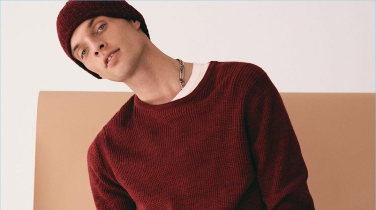 Playing it casual, Rocky Harwood sports a Todd Snyder merino waffle crewneck sweater in red marl.