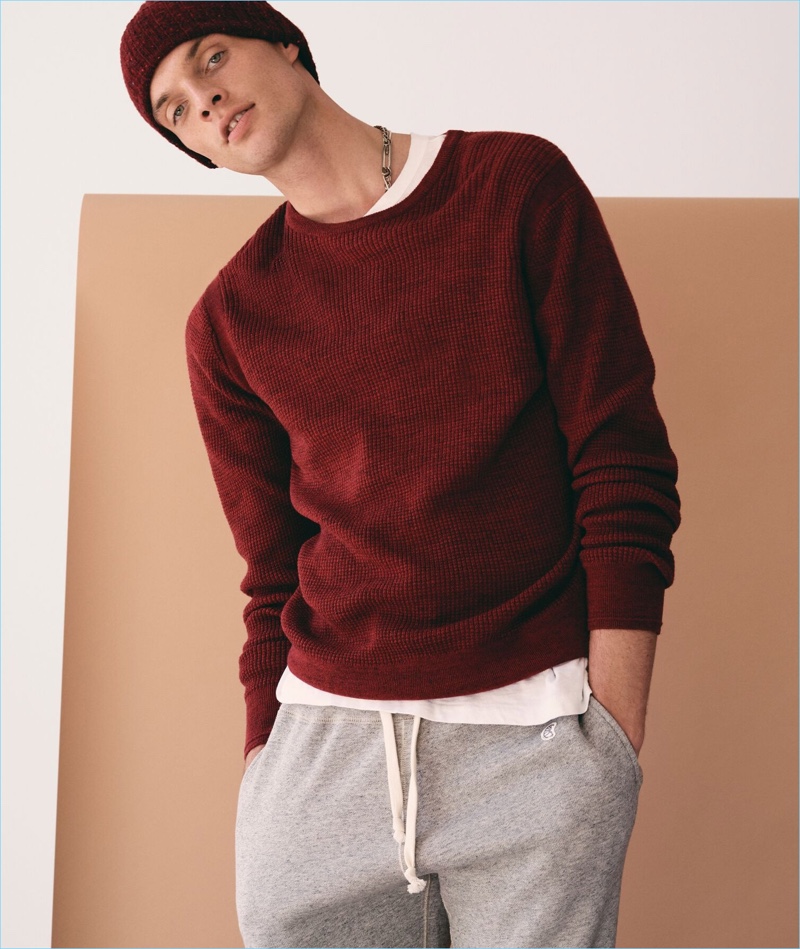 Playing it casual, Rocky Harwood sports a Todd Snyder merino waffle crewneck sweater in red marl.