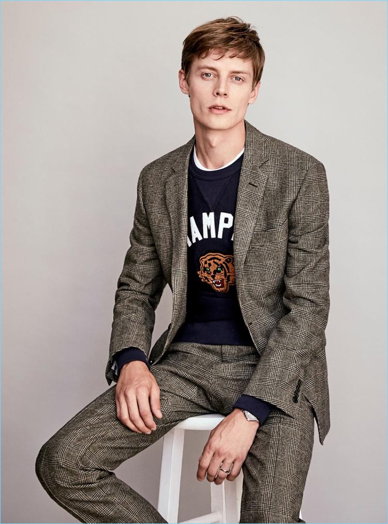 Bringing a fun sporty attitude to suiting, Janis Ancens wears a Todd Snyder Black Label Glen Plaid suit with a sweatshirt.