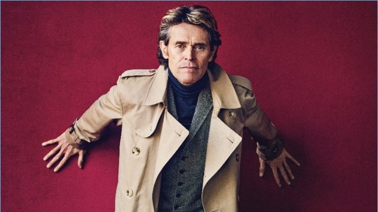 Front and center, Willem Dafoe wears a Burberry trench, POLO Ralph Lauren vest, Hermès turtleneck sweater, and Ralph Lauren trousers. Church's shoes complete Dafoe's look.
