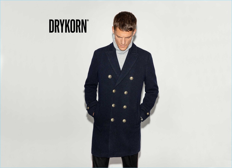 Danny Beauchamp dons a Drykorn double-breasted coat with a Minimum sweater.